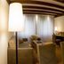 Gronauer Tannenhof in Bergisch Gladbach, cozy wood-paneled hotel suite with seating area and bedroom