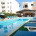 New York Plaza Hotel Apartments in Paphos with outdoor pool and blue sun loungers