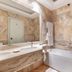 Borgo Palace Hotel in Sansepolcro bathroom with marble walls, double sink, and bathtub