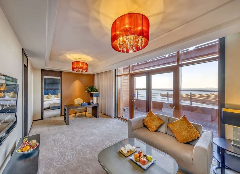 Siko Grand Hotel Suzhou Yangcheng Lake suite with lake-view balcony and seating area in Suzhou