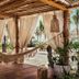 Jungala Hotel at VidantaWorld Riviera Maya in Cancún with a hammock on a tropical beach cabana