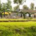 Hotel Waldesruh Am See in Aumühle with lakeside terrace, yellow umbrellas and green lawn