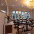 Churfuerstliche Waldschaenke dining room in Moritzburg with chandelier, set tables and bay windows