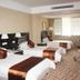 Xiang Ming Holiday Hotel in Huangshan guest room with three beds and a window seating area