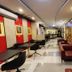Hotel 99 Cubao Manila lobby seating area with ornate wood wall art and tables