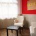 Zum Hollander Hof in Bad Arolsen room with white armchairs, black table and bright window