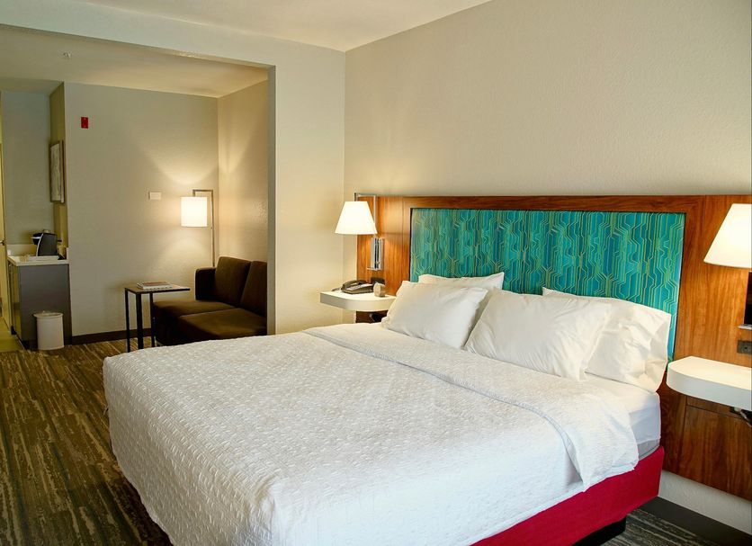 Hampton Inn & Suites by Hilton Cathedral City Palm Springs guest room with king bed and sitting area