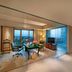 ITC Gardenia, a Luxury Collection Hotel, Bengaluru suite with desk, seating area and city-view window