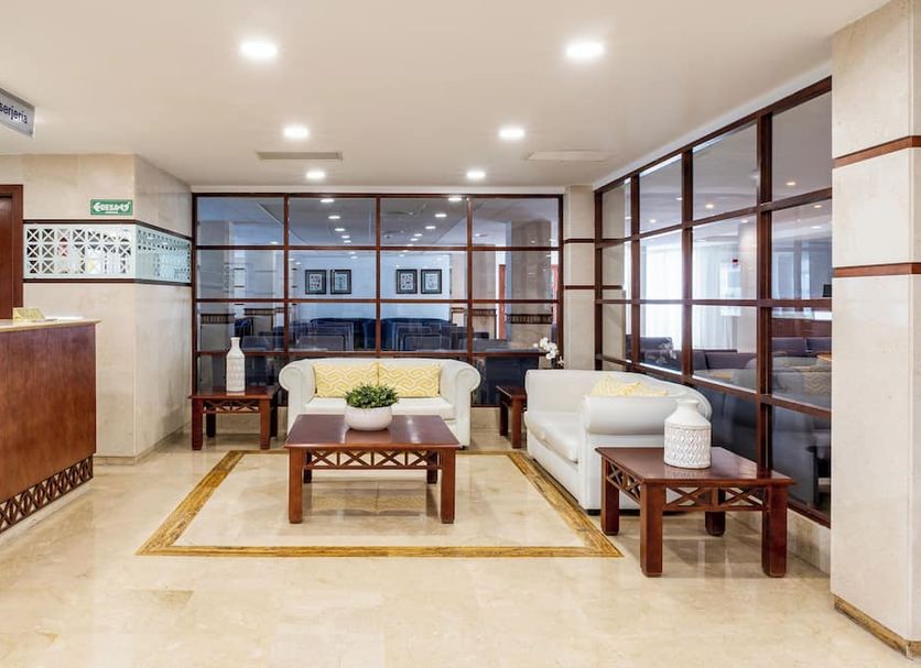 Globales Playa Santa Ponsa lobby seating area with sofa, armchairs and glass walls in Santa Ponsa