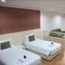 Baan Klang Hua Hin room with two twin beds, seating area, and wood flooring in Hua Hin