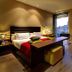 Olivia Plaza Hotel Barcelona room with king bed, desk, and city view through large windows