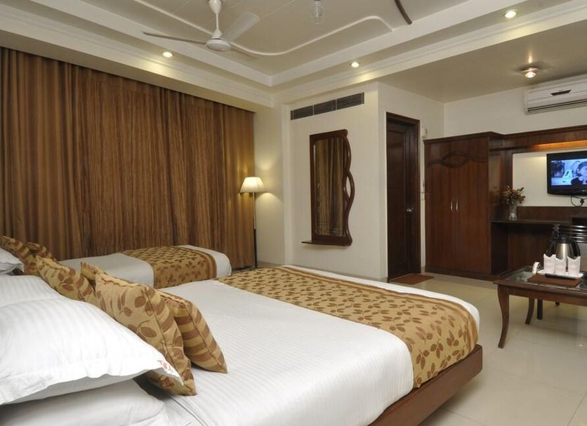 Hotel Shipra International in New Delhi guest room with twin beds, seating area, and TV