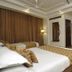 Hotel Shipra International in New Delhi guest room with twin beds, seating area, and TV