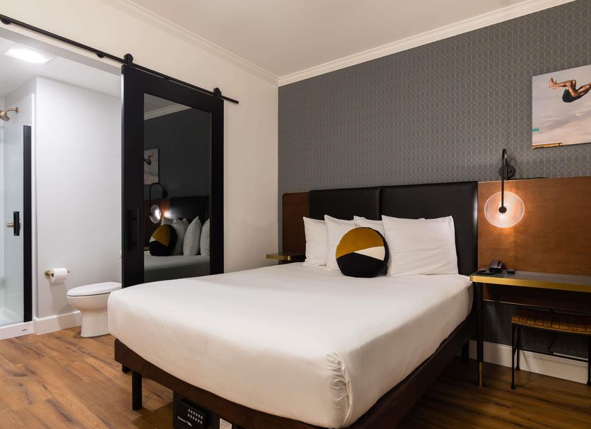 Hotel Stratford San Francisco room with king bed, desk, and modern bathroom door in San Francisco