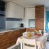 Vela Blu Camping Village, Cavallino Treporti: bright kitchenette with dining table and sofa seating