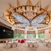 Pullman Shanghai Central banquet hall with chandeliers, round tables and large windows in Shanghai