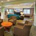 Worldmark Long Beach lobby lounge with checkered armchairs, round table, sofa and front desk