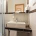 Europa Kehl Hotel bathroom with glass shower, wall-mounted sink, mirror, and towel rack in Kehl