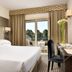 Fh55 Grand Hotel Mediterraneo room in Florence with balcony doors, desk, and city views
