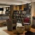 Karma Bavaria in Schliersee lounge with fireplace, armchairs, bookshelves and warm seating area
