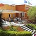 Residence Corte Dei Venti in Budoni with outdoor terrace seating, steps, and landscaped hedges
