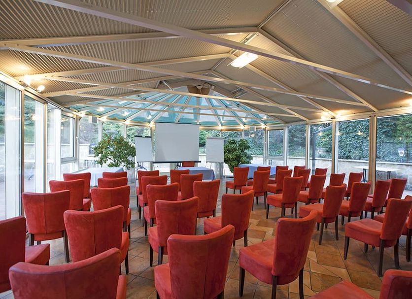 Hotel Mediterran Budapest conference room with red chairs and glass walls