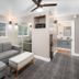 The Inn at Boatworks, Lake Tahoe suite with gray sectional, mirrored closet, ceiling fan, and bathroom view