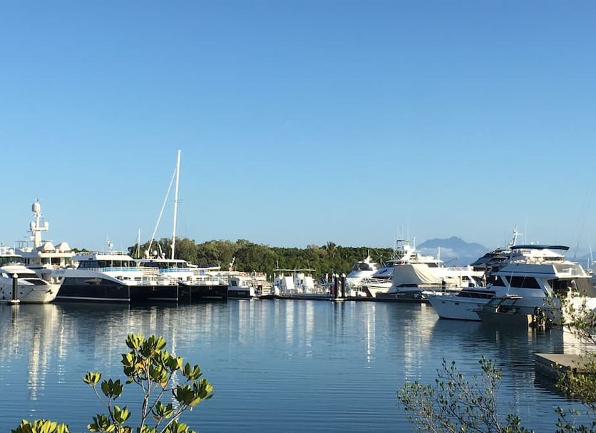 The Newport On Macrossan in Port Douglas with marina and yachts on calm water