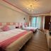 Ct Theme Suite in Kaohsiung City: pink-accented twin bedroom with chandelier, TV and balcony doors