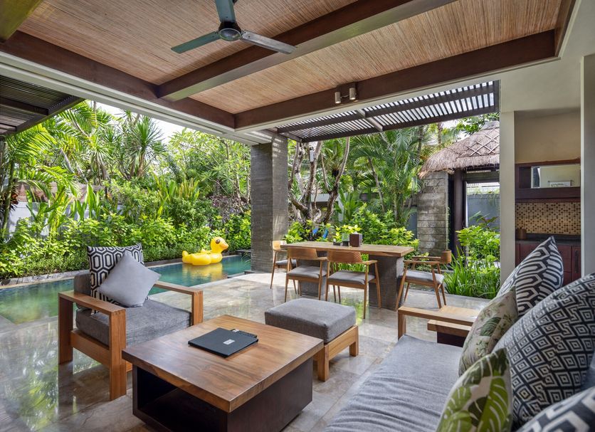 Le Jardin Villas Seminyak in Kuta: villa patio with plunge pool, lounge chairs, and tropical garden view