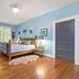 Mountain Meadows Inn & Chalet Suites in Ashford: airy guest room with wood bed, twin bed, and hardwood floors