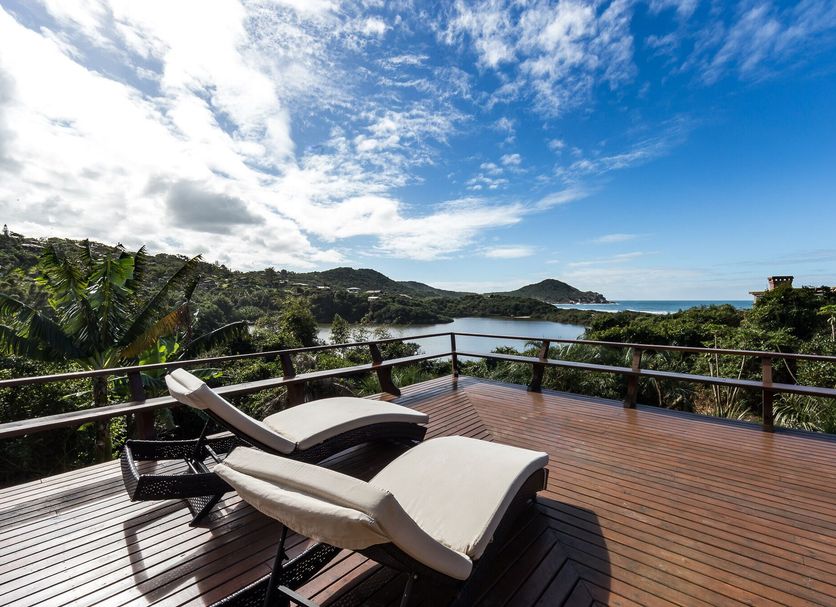 Fazenda Verde Praia do Rosa deck with lounge chairs and panoramic ocean and hillside views in Imbituba
