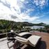 Fazenda Verde Praia do Rosa deck with lounge chairs and panoramic ocean and hillside views in Imbituba