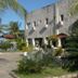 Beach Hotel Jacuma in João Pessoa with stone facade, palm trees, and beachside ocean view