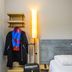 Ibis Budget Rochefort guest room with bed, wall shelves, coat rack and floor lamp