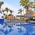 Mar Paraiso Queen, Acapulco: palm-lined pool with thatched palapa and reflected sky