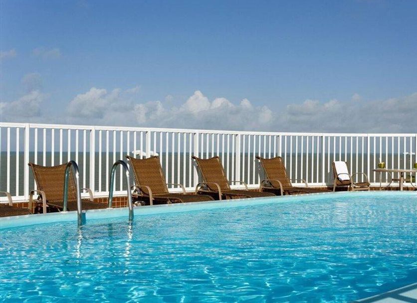 Intercity João Pessoa rooftop pool with lounge chairs and ocean view in João Pessoa
