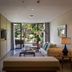 Plataran Ubud Hotel And Spa suite with sofa, balcony, and tropical garden view in Denpasar