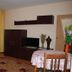 City Stay In Varna room with balcony doors, TV cabinet, dining table, and yellow curtains