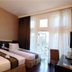Vio Hotel Cimanuk Bandung in Bandung guest room with two twin beds and balcony doors