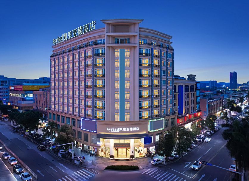 Kyriad Hotel Guangzhou Panyu Aoyuan Plaza in Guangzhou at dusk on a busy street corner