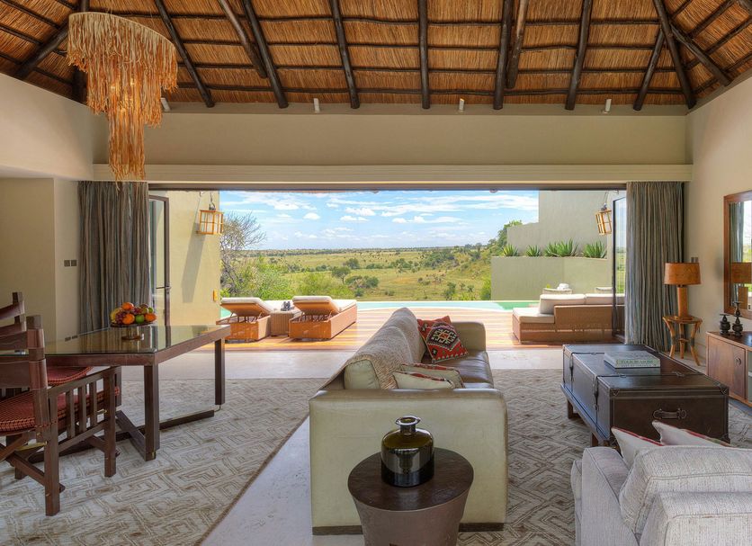 Four Seasons Safari Lodge Serengeti living room opening to Serengeti view and outdoor seating