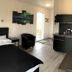 Afternoon Cottages in Hella room with bed, armchair, kitchenette and outdoor door
