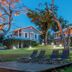 Club Seabourne Hotel in Culebra with lawn, lounge chairs, and illuminated cottages at dusk