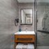 Hanting Hotel Dongguan Changan Wanda bathroom with glass shower, vanity and mirror in Dongguan
