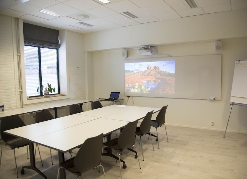 Lillehammer Stasjonen Hotel meeting room in Lillehammer with conference table, chairs, projector and whiteboard