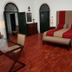 Monte Dos Apóstolos in Portalegre: spacious room with red-and-beige bed, glass desk and arched doors