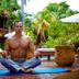 Magic Blue Spa Boutique Hotel Adults Only in Playa del Carmen, man meditating on yoga mat by tropical pool