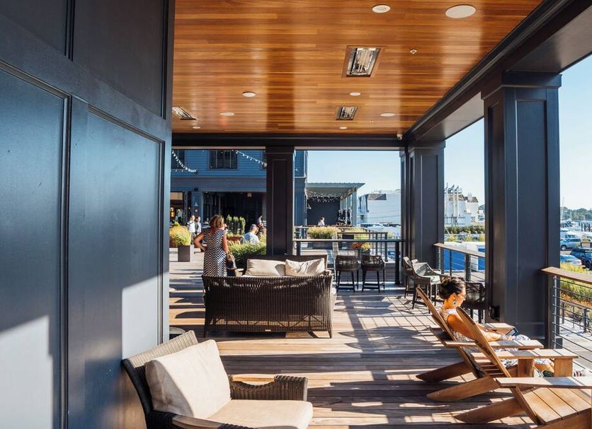 Hammetts Hotel in Newport balcony lounge with wicker chairs and marina views