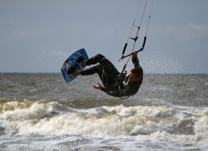 Hotel Noordzee in Katwijk: kitesurfer airborne over waves on the sea